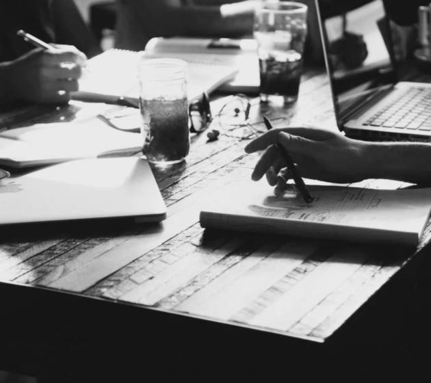 Several professionals sitting at a table working on ideas